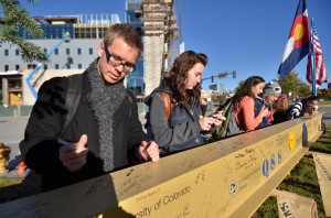 Students sign the final beam placed in the University of Colorado Denver Academic Building 1. (CU Denver University Communications photo)