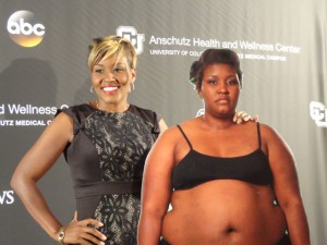 Charita poses with a cutout of her former self. (University of Colorado Hospital photo)